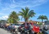 Fila de vehículos y motocicletas detenidos en una vía durante la espera para abastecerse de combustible.