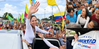 María Corina Machado saluda a una multitud de simpatizantes durante su recorrido por Venezuela y muestra una bandera con el mensaje “Libertad a la venezolana”.